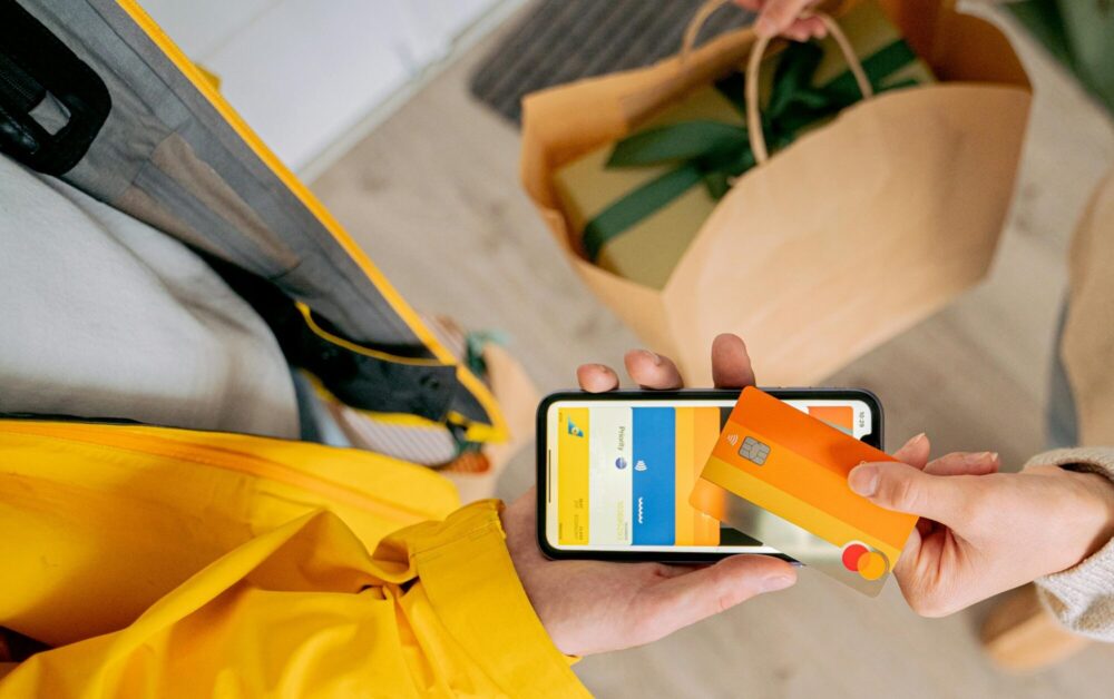 Person making contactless payment with a credit card using smartphone. Online shopping and delivery concept.